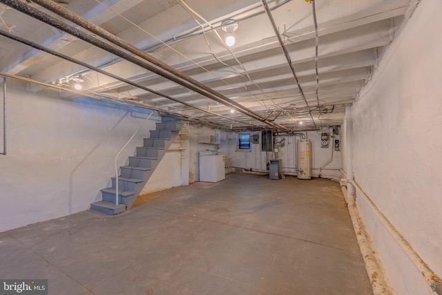 basement with water heater and washer / clothes dryer