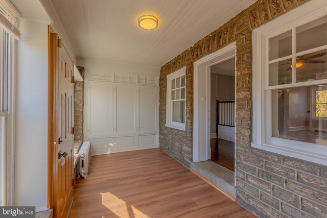 interior space with radiator heating unit and wood-type flooring