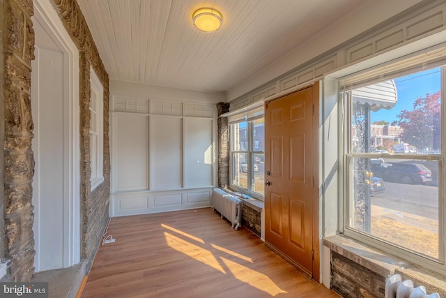 unfurnished sunroom with radiator