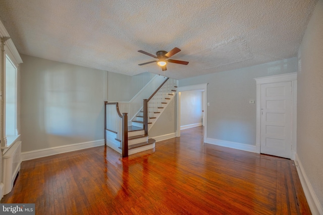 interior space featuring ceiling fan, a textured ceiling, and dark hardwood / wood-style flooring