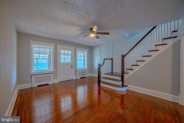 entryway featuring radiator heating unit, a textured ceiling, hardwood / wood-style flooring, and ceiling fan