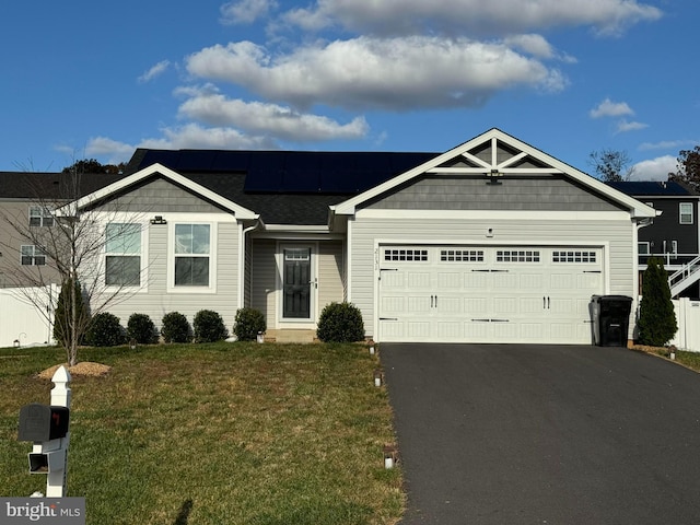 view of front of home featuring a garage and a front yard