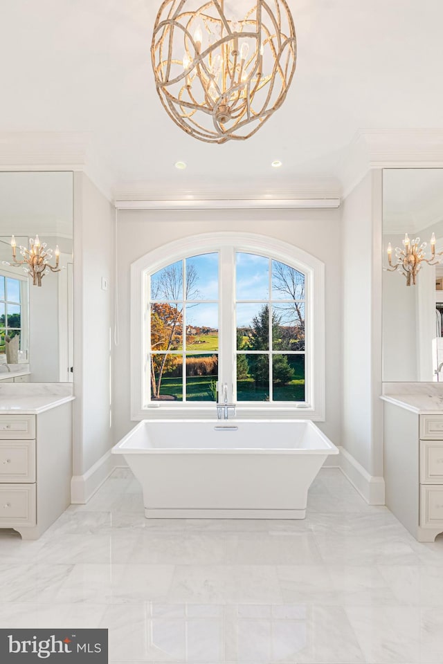 bathroom featuring a healthy amount of sunlight, vanity, a tub, and a notable chandelier