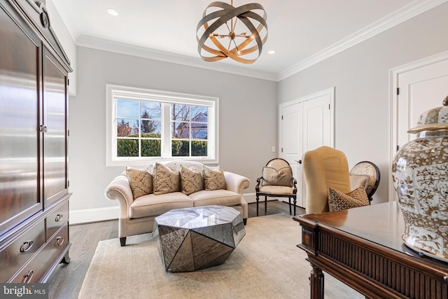 living room with a chandelier, ornamental molding, and light wood-type flooring