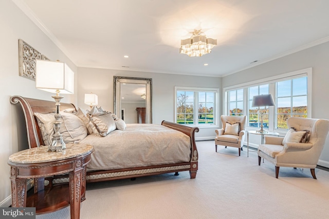 bedroom with an inviting chandelier, light colored carpet, and ornamental molding