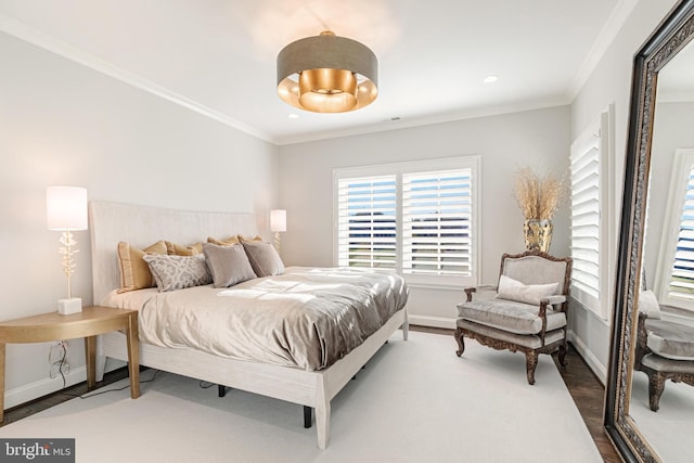 bedroom featuring wood-type flooring and ornamental molding