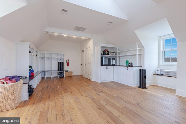 interior space with lofted ceiling and light wood-type flooring