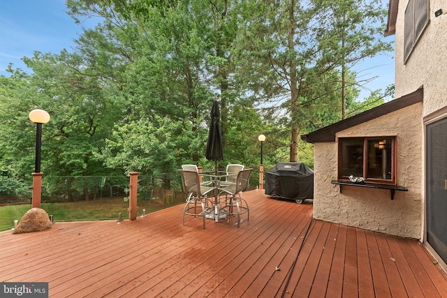 wooden terrace featuring a grill