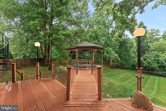 deck featuring a gazebo and a lawn