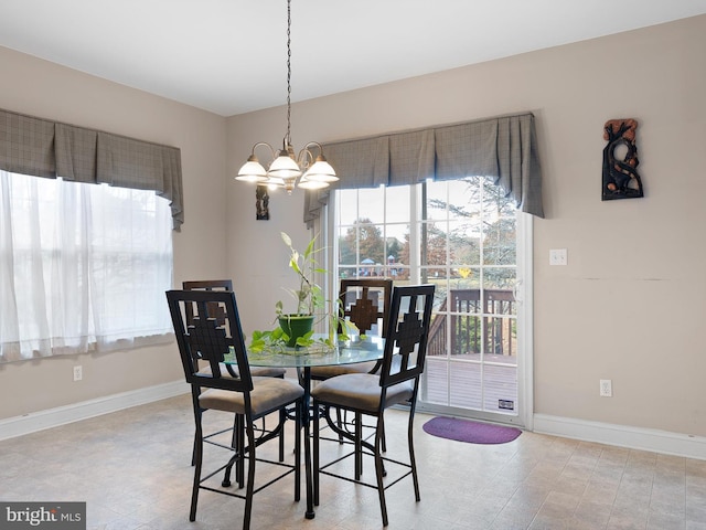 dining space featuring a notable chandelier