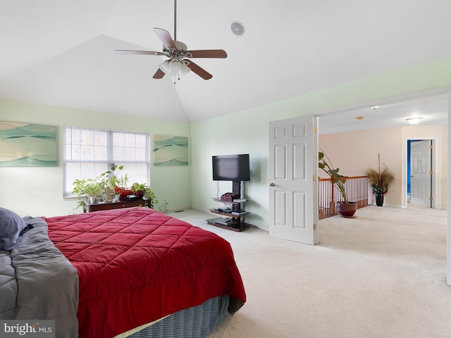 carpeted bedroom with ceiling fan and vaulted ceiling