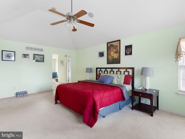 carpeted bedroom featuring ceiling fan and vaulted ceiling