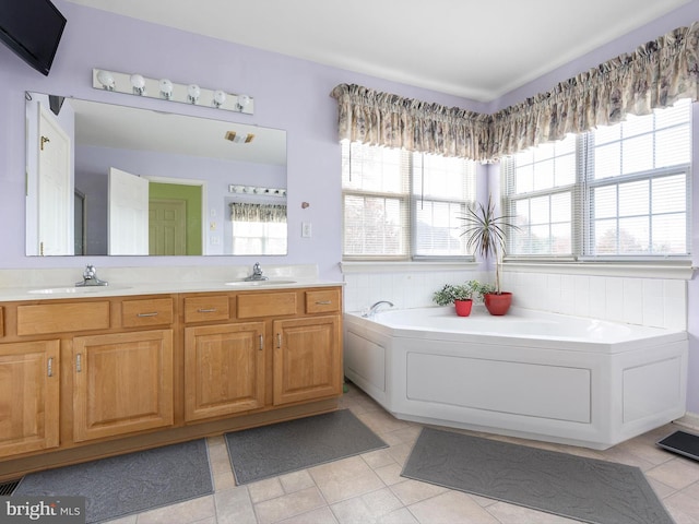 bathroom featuring tile patterned flooring, vanity, and a tub