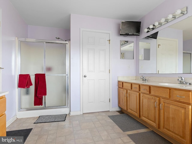 bathroom featuring vanity and a shower with door