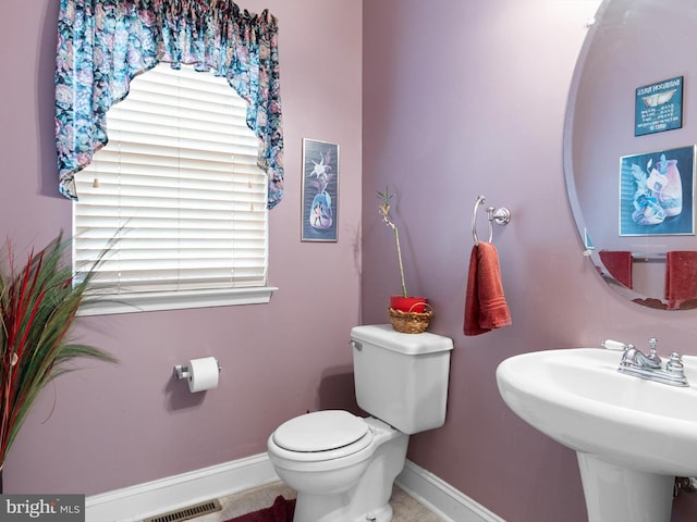 bathroom with tile patterned flooring, toilet, and sink