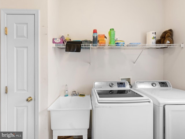 laundry area featuring washer and clothes dryer and sink