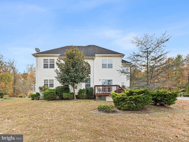 back of house with a lawn and a deck