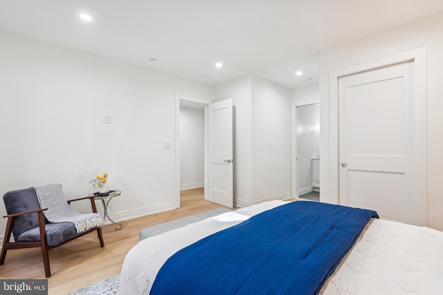 bedroom featuring hardwood / wood-style floors and a closet