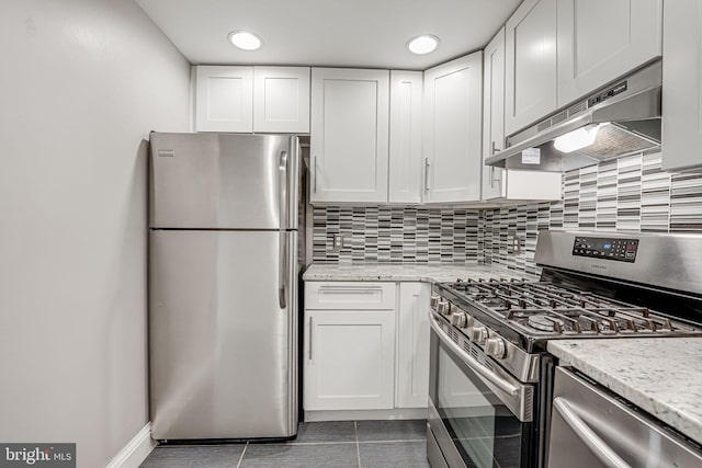 kitchen featuring white cabinetry, light stone counters, and stainless steel appliances