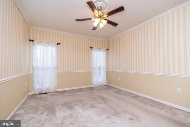 unfurnished room with ceiling fan, light colored carpet, and ornamental molding