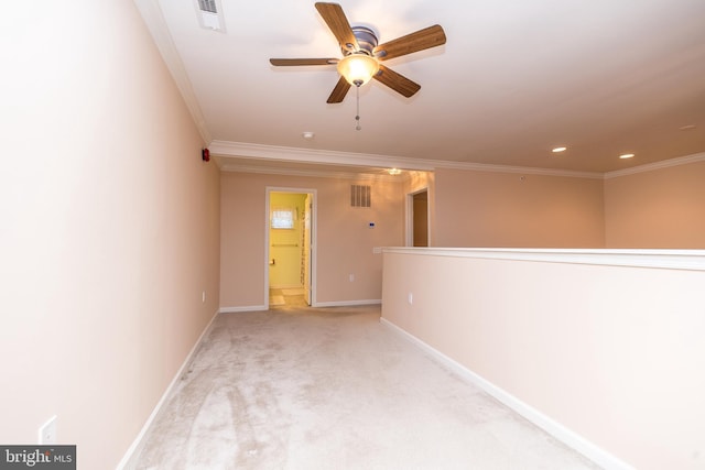 carpeted spare room with ceiling fan and ornamental molding