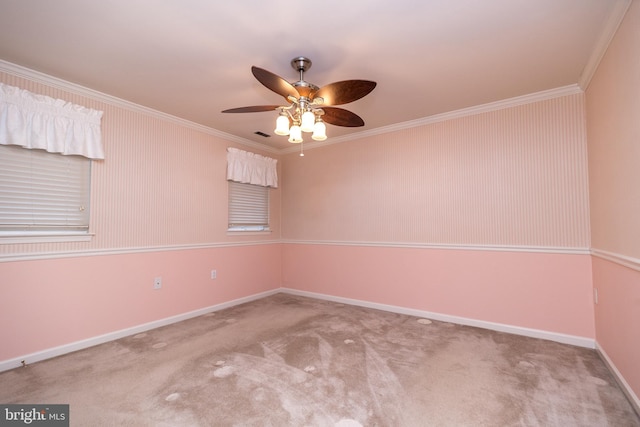 carpeted empty room with ceiling fan and ornamental molding