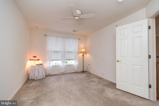 unfurnished room with ceiling fan, lofted ceiling, and light carpet