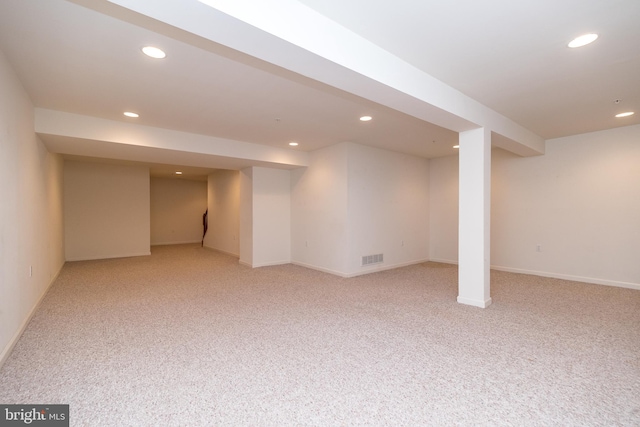 basement featuring light colored carpet