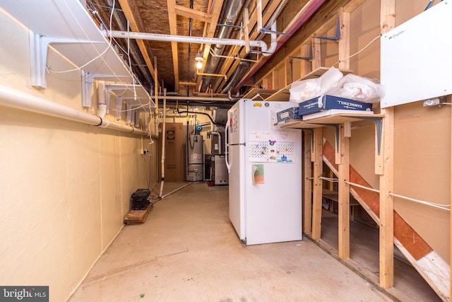 basement with white fridge and water heater