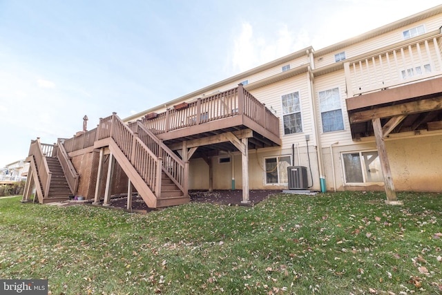 back of property with cooling unit, a deck, and a yard