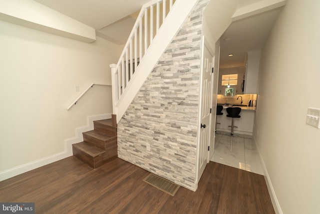 stairway featuring wood-type flooring