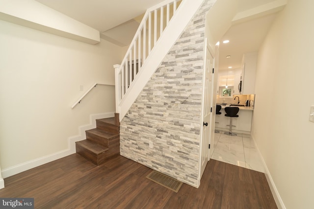 staircase with wood-type flooring