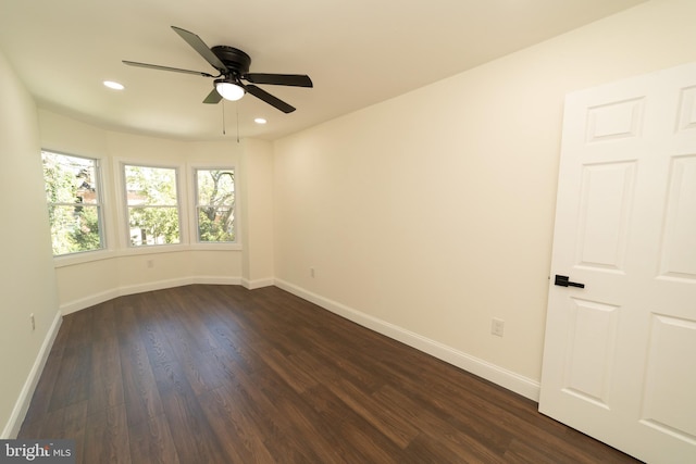 unfurnished room with dark wood-type flooring and ceiling fan