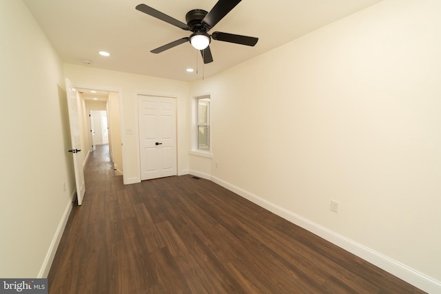 interior space featuring dark wood-type flooring and ceiling fan