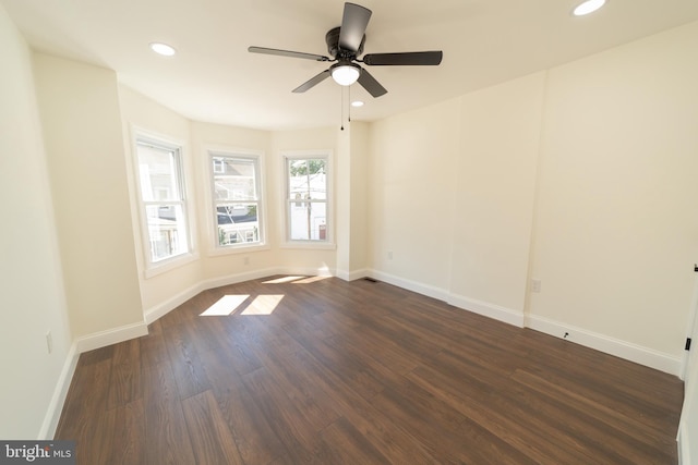 unfurnished room with ceiling fan and dark hardwood / wood-style floors