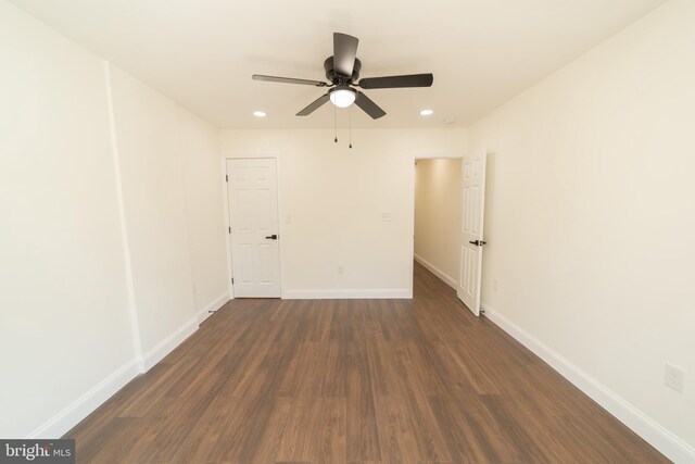 empty room featuring ceiling fan and dark hardwood / wood-style floors