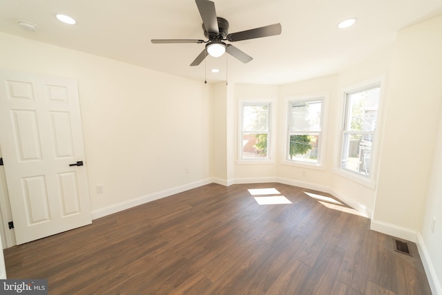 empty room with ceiling fan and dark hardwood / wood-style floors