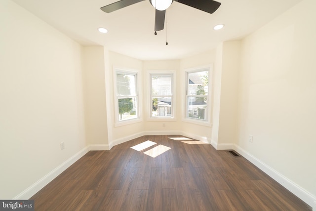 unfurnished room with dark wood-type flooring and ceiling fan