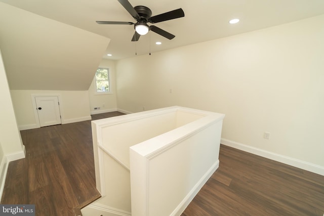 interior space featuring dark wood-type flooring and vaulted ceiling