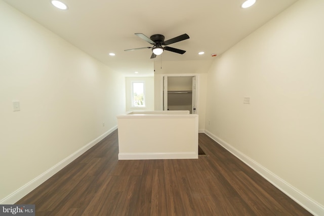 unfurnished room with dark hardwood / wood-style floors and ceiling fan