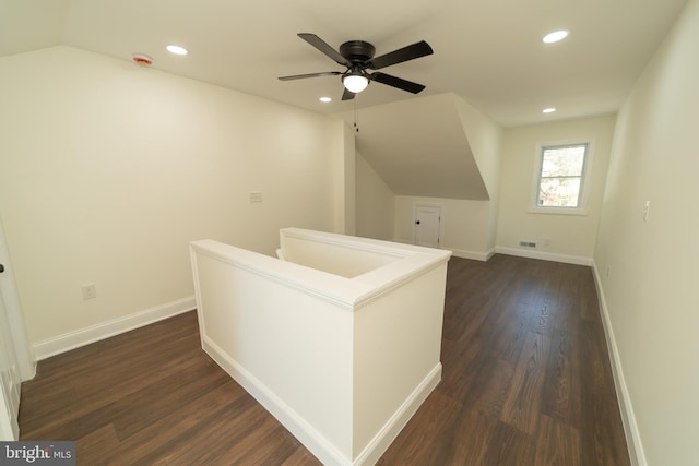 additional living space with ceiling fan, vaulted ceiling, and dark hardwood / wood-style floors