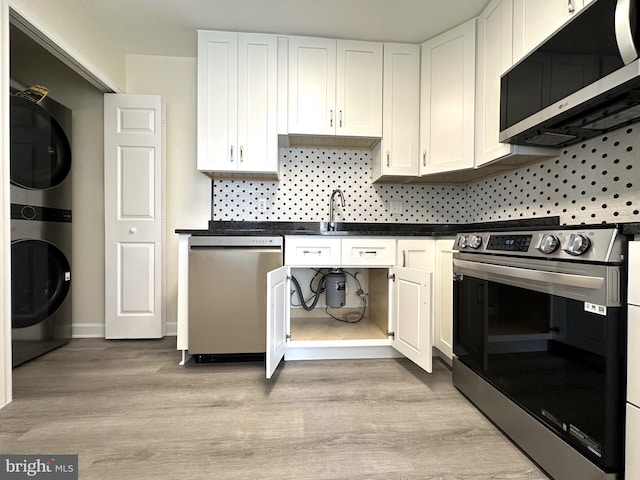 kitchen featuring white cabinets, light wood-type flooring, and appliances with stainless steel finishes