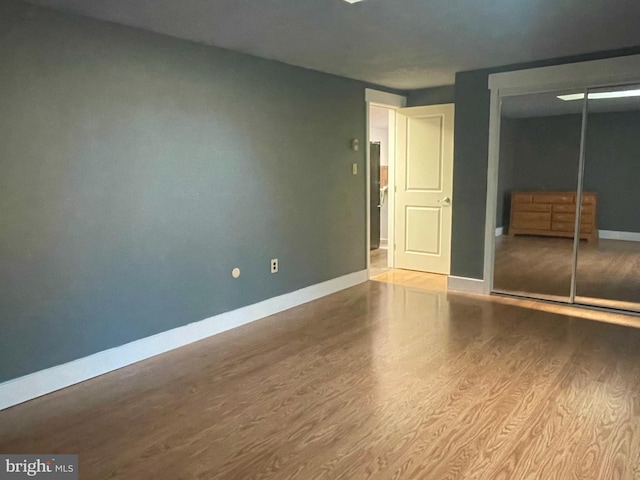 unfurnished bedroom with a closet and light hardwood / wood-style flooring