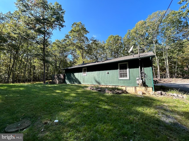 view of property exterior with a yard