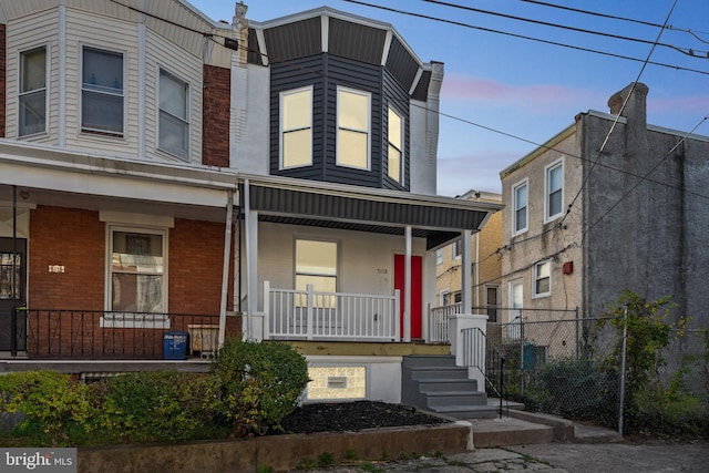 townhome / multi-family property with covered porch