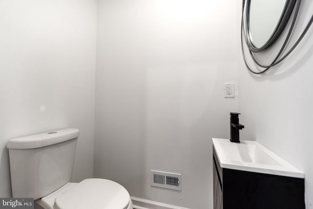 bathroom featuring toilet and vanity