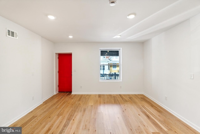 spare room with wood-type flooring