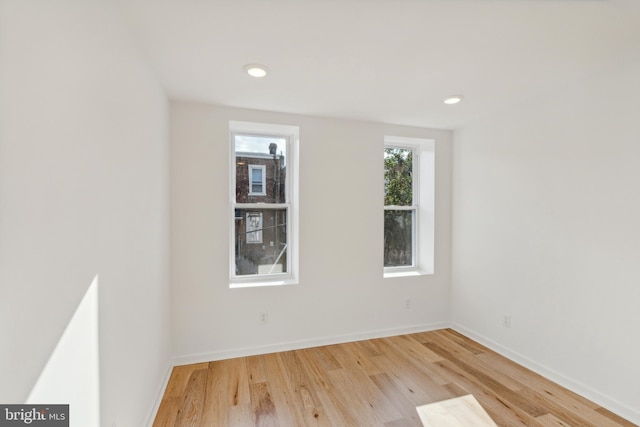 unfurnished room with light hardwood / wood-style flooring