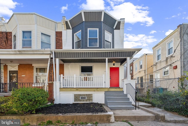 townhome / multi-family property with a porch