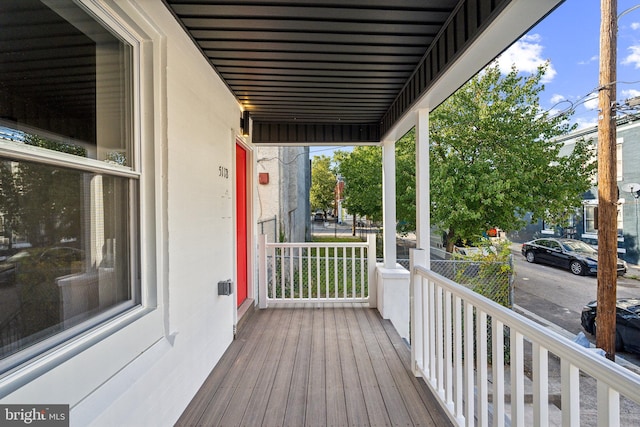 wooden terrace featuring covered porch